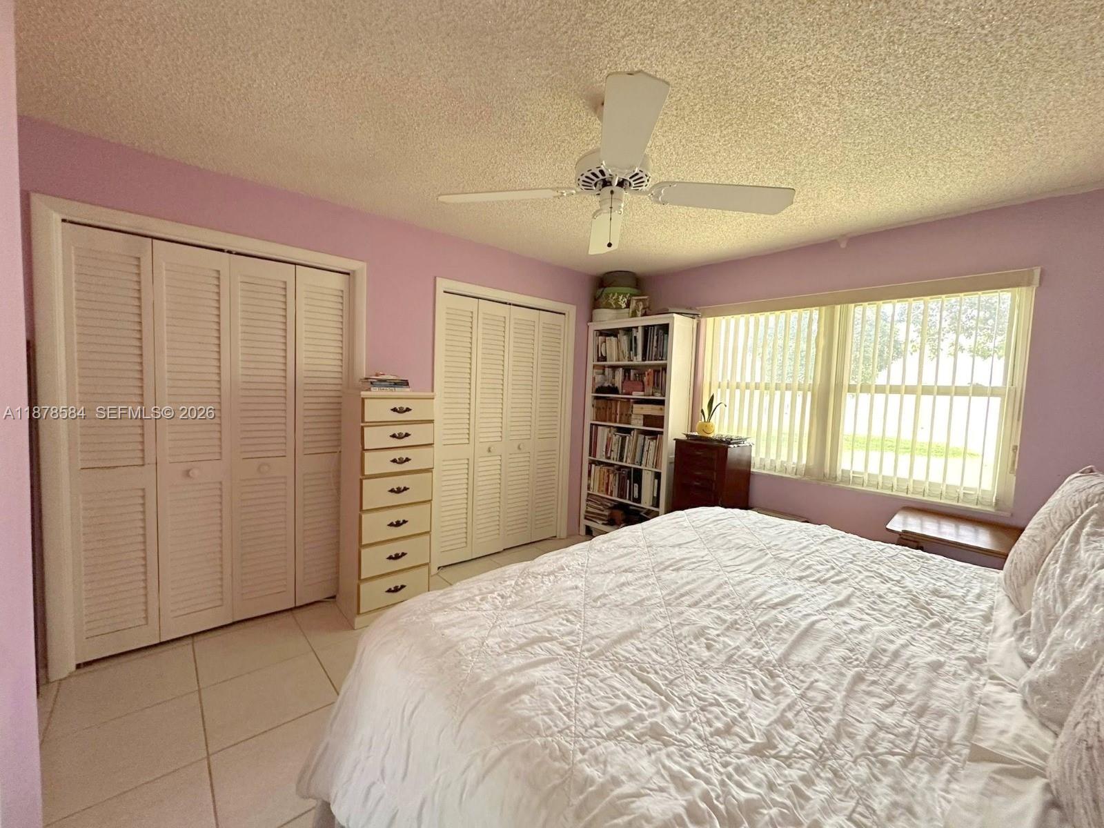 285 North High Point, Unit A Boynton Beach, FL 33435 - Photo 17 of 32 a bedroom with a large bed and a window