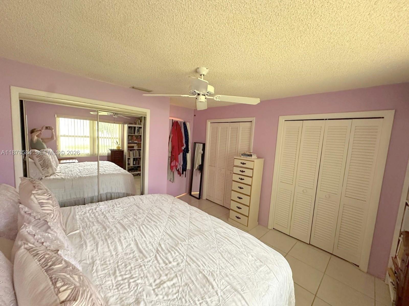 285 North High Point, Unit A Boynton Beach, FL 33435 - Photo 18 of 32 a bedroom with a large bed and a chandelier
