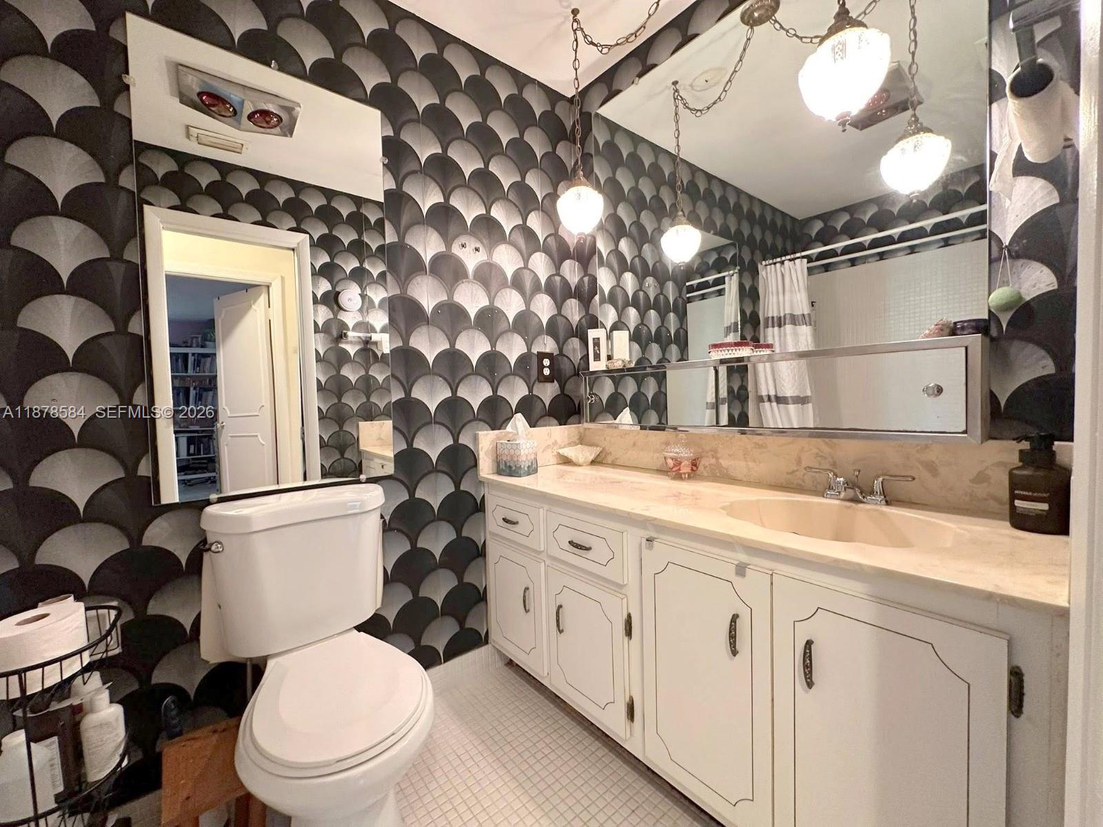 285 North High Point, Unit A Boynton Beach, FL 33435 - Photo 19 of 32 a bathroom with a granite countertop toilet sink and mirror