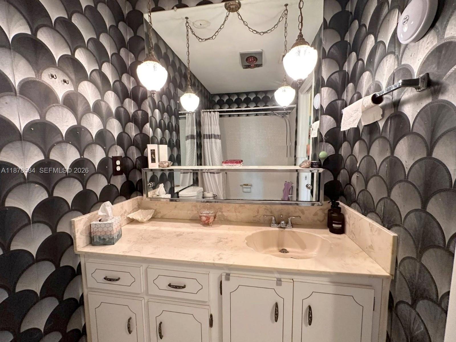 285 North High Point, Unit A Boynton Beach, FL 33435 - Photo 20 of 32 a bathroom with a sink and a mirror