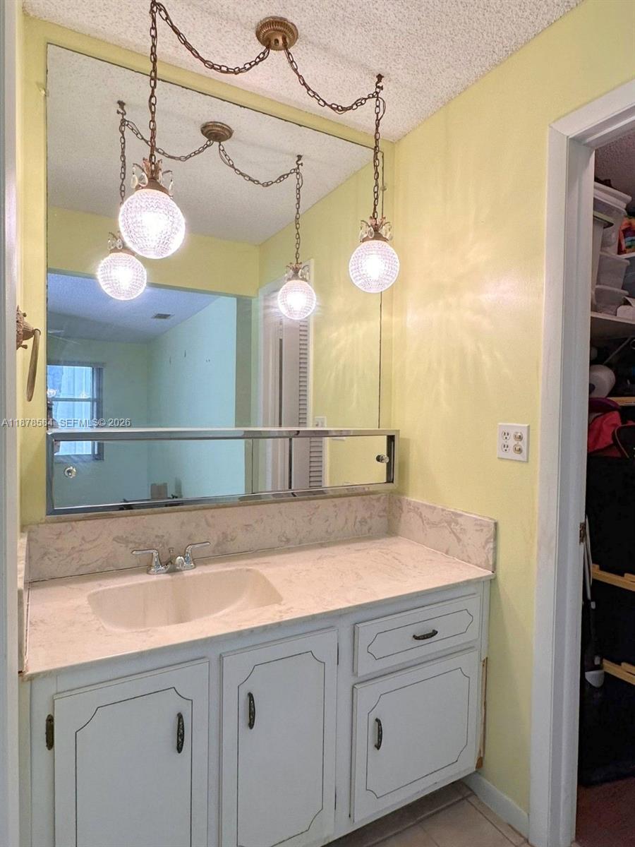 285 North High Point, Unit A Boynton Beach, FL 33435 - Photo 22 of 32 a bathroom with a sink and a mirror