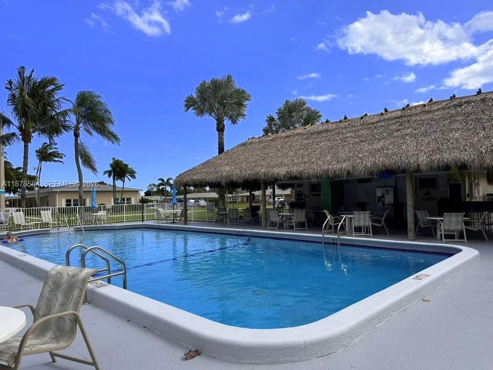 285 North High Point, Unit A Boynton Beach, FL 33435 - Photo 32 of 32 a view of a swimming pool with a patio