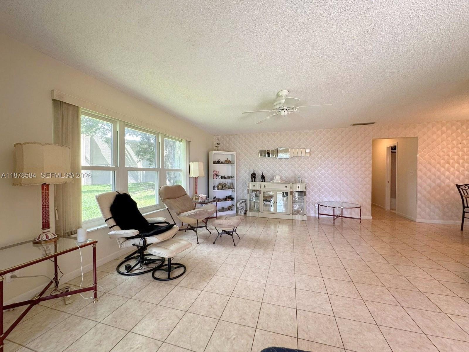 285 North High Point, Unit A Boynton Beach, FL 33435 - Photo 4 of 32 a living room with furniture and floor to ceiling window