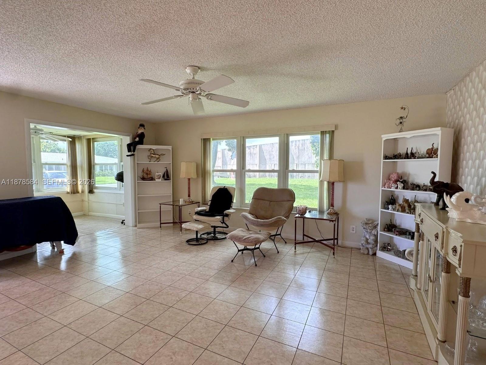 285 North High Point, Unit A Boynton Beach, FL 33435 - Photo 6 of 32 a living room with furniture and a flat screen tv