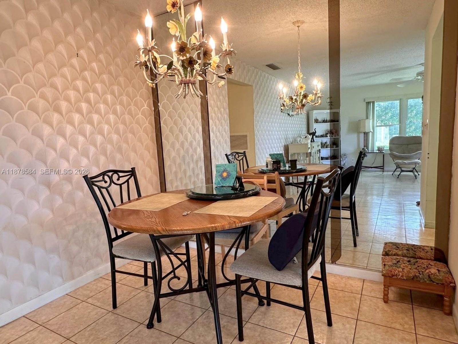 285 North High Point, Unit A Boynton Beach, FL 33435 - Photo 8 of 32 a view of a dining room with furniture and chandelier