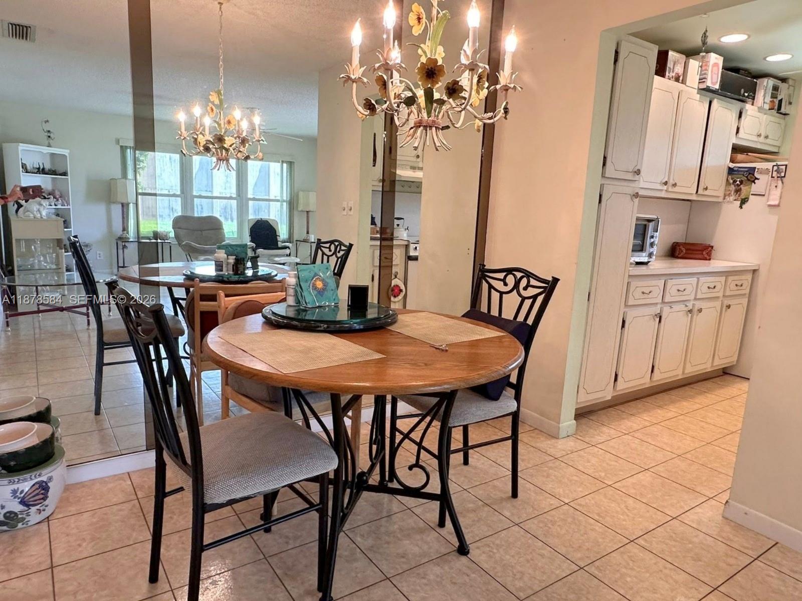 285 North High Point, Unit A Boynton Beach, FL 33435 - Photo 9 of 32 a view of a dining room with furniture and chandelier