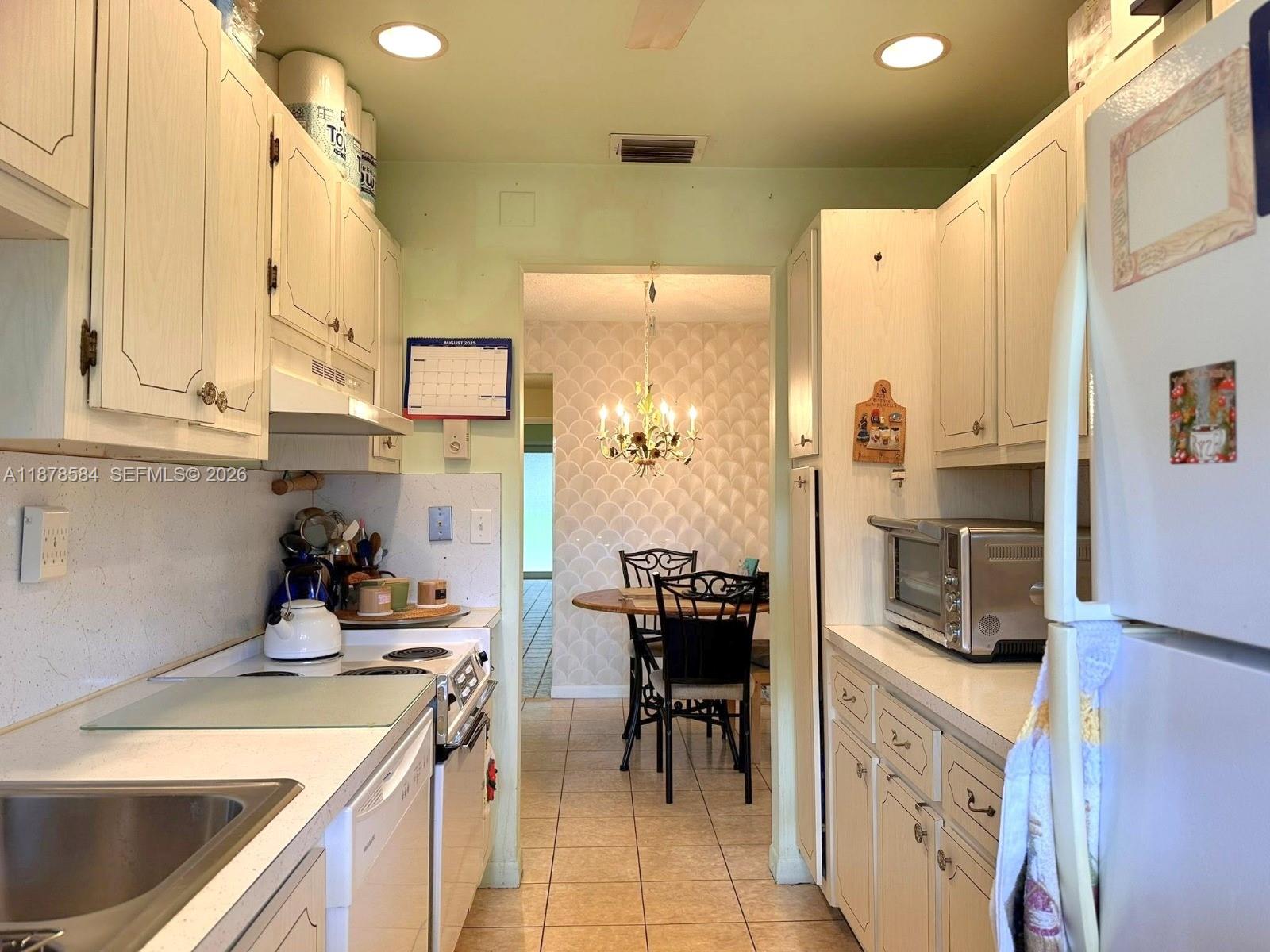 285 North High Point, Unit A Boynton Beach, FL 33435 - Photo 10 of 32 a kitchen with a sink stove and refrigerator