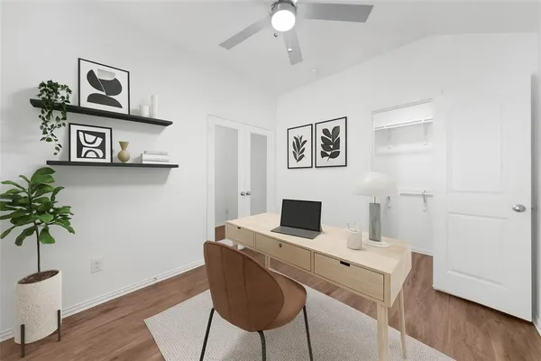 a view of a workspace with furniture and wooden floor