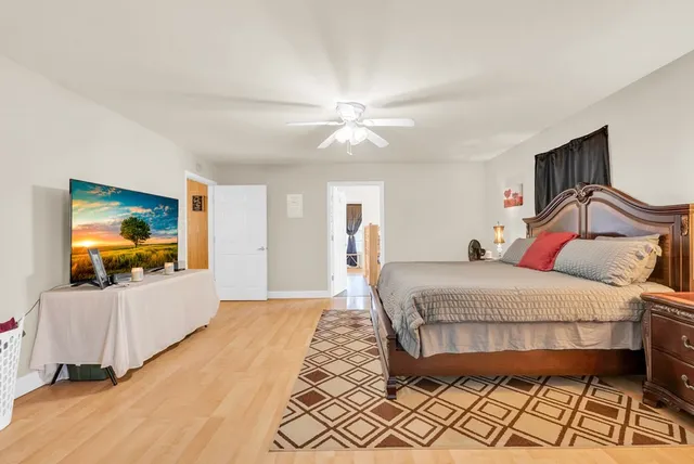 a bedroom with a bed and a flat screen tv