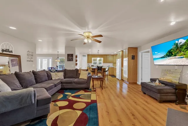 a living room with furniture ceiling fan and a rug