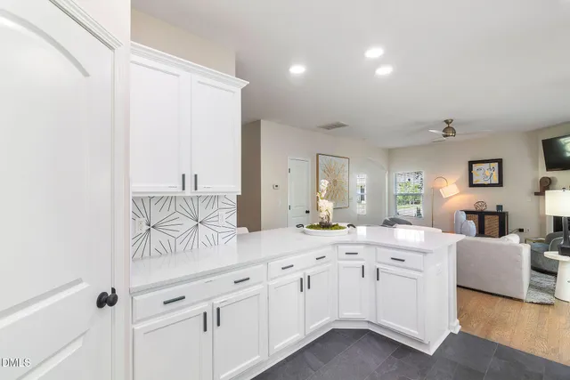 a spacious bathroom with a granite countertop sink a mirror and a