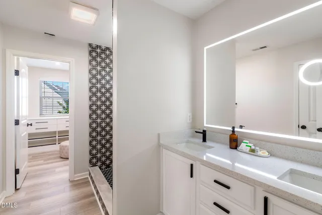 a bathroom with a shower and a sink