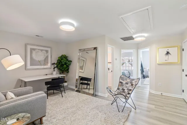 a view of a livingroom with furniture and a potted plant