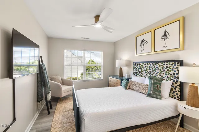 a bedroom with a large bed and a window