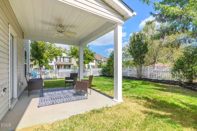 a view of a porch with furniture and a yard