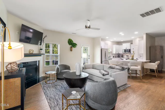 a living room with fireplace furniture and a flat screen tv