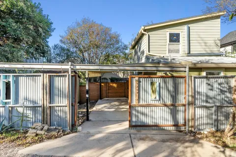 a view of a house with wooden fence