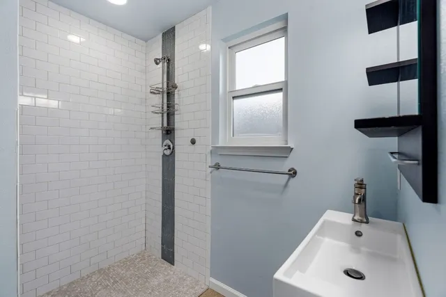 a bathroom with a toilet sink and a mirror