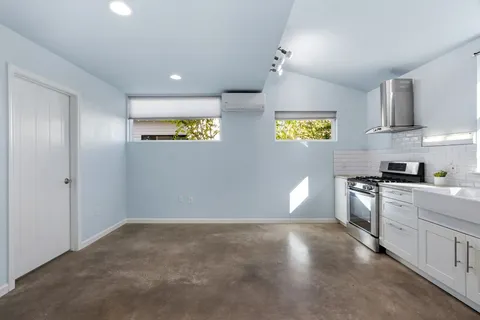 a kitchen with stainless steel appliances granite countertop a stove and a refrigerator