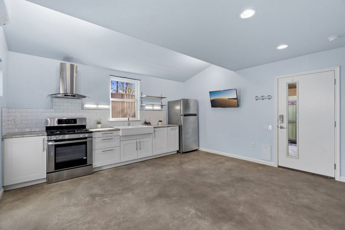 1309 Singleton Avenue, Unit 2 Austin, TX 78702 - Photo 6 of 25 a kitchen with stainless steel appliances a refrigerator and a stove