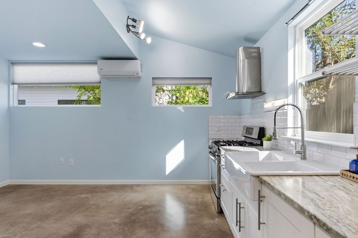 1309 Singleton Avenue, Unit 2 Austin, TX 78702 - Photo 8 of 25 a kitchen with stainless steel appliances granite countertop a sink a stove and a granite counter tops with a window