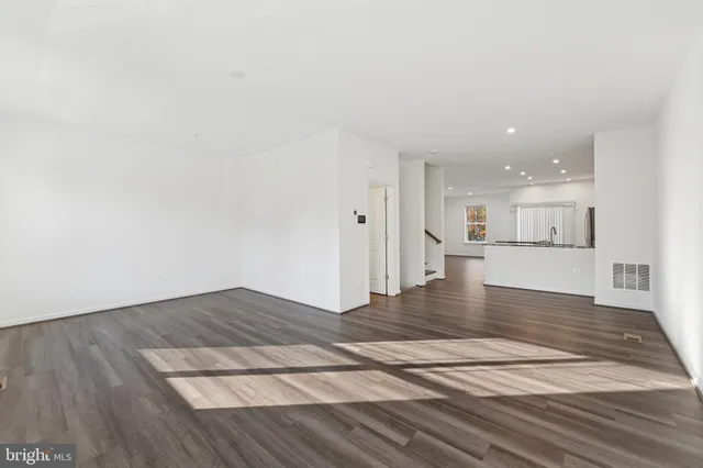a view of kitchen and hall with wooden floor