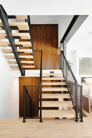 a bed sitting in a bedroom next to a large window