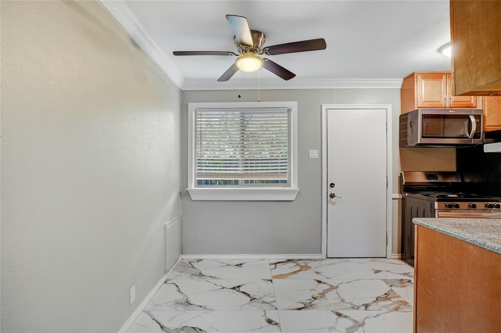 3310 Douglas Avenue, Unit B Dallas, TX 75219 - Photo 4 of 11 a bedroom with a bed and a television