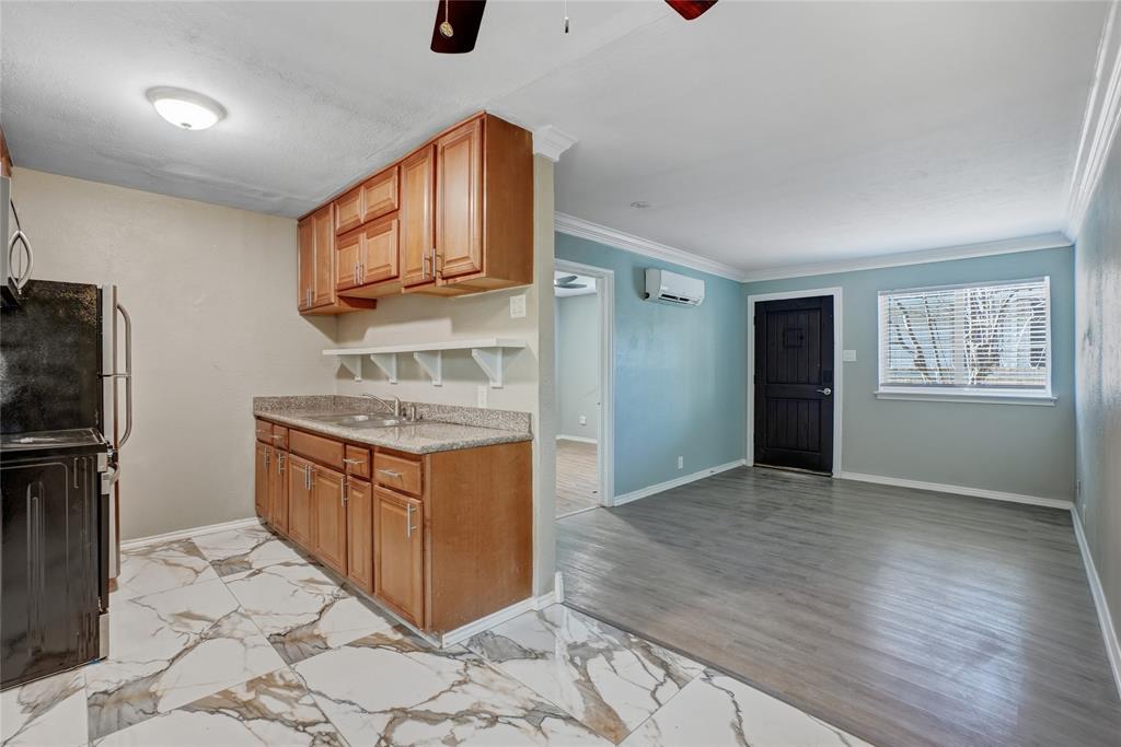3310 Douglas Avenue, Unit B Dallas, TX 75219 - Photo 6 of 11 a kitchen with granite countertop a stove a refrigerator and a sink