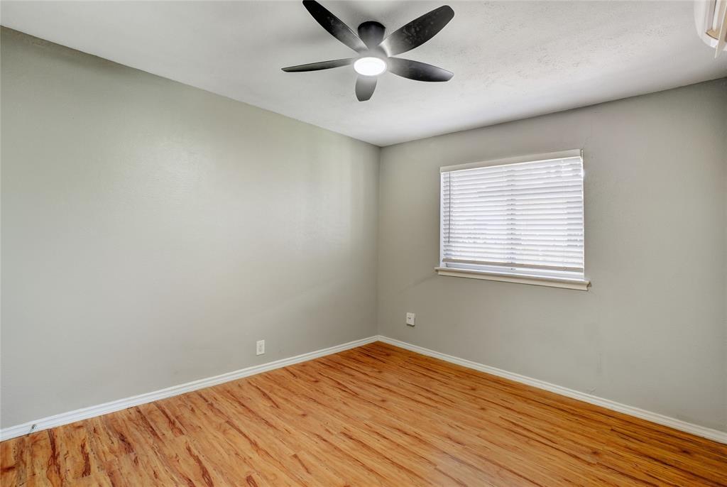 3310 Douglas Avenue, Unit B Dallas, TX 75219 - Photo 7 of 11 a view of empty room with wooden floor and fan