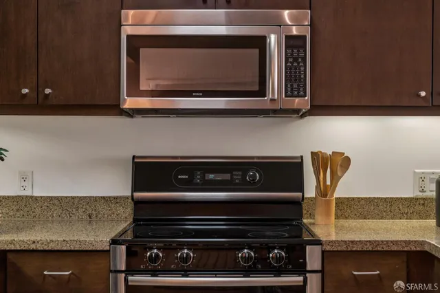 a kitchen with a refrigerator sink and cabinets