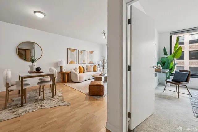 a dining room with furniture and a potted plant