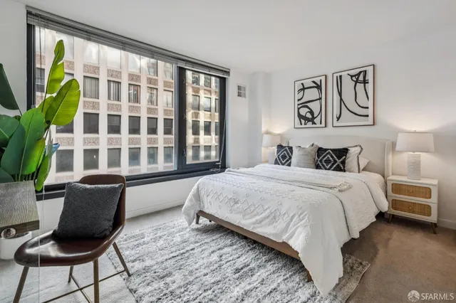 a bedroom with a bed and a dresser in it