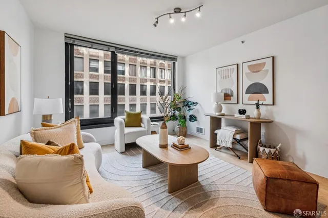 a living room with furniture or couch and a potted plant