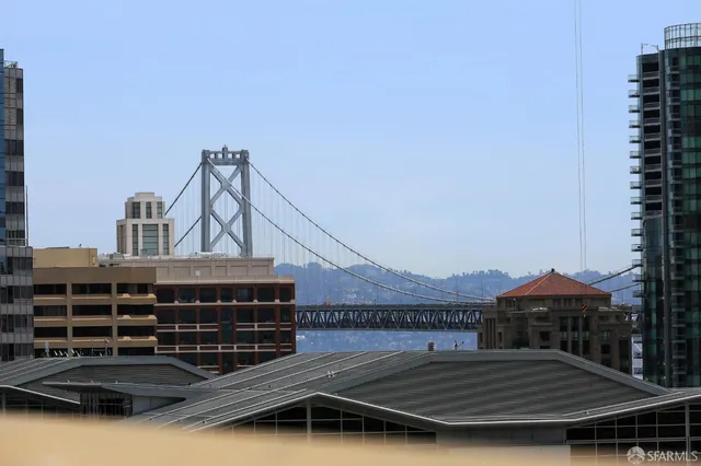 a living room with furniture a chandelier and a potted plant