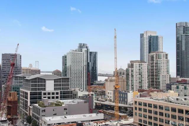 a living room with furniture and large windows