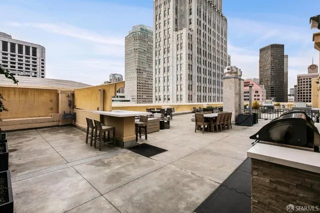 a view of a patio with a dining table and chairs