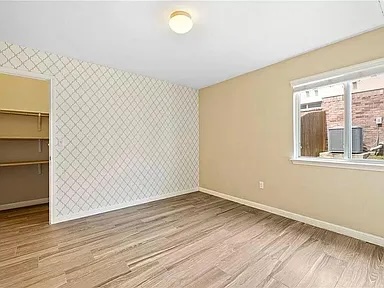 417 Tula Trail Leander, TX 78641 - Photo 12 of 24 a view of an empty room with wooden floor and a window