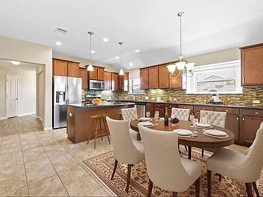 417 Tula Trail Leander, TX 78641 - Photo 5 of 24 a dining room with stainless steel appliances kitchen island granite countertop a dining table chairs and view living room