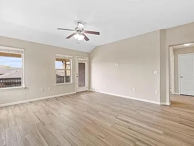 417 Tula Trail Leander, TX 78641 - Photo 7 of 24 a view of empty room with wooden floor and fan