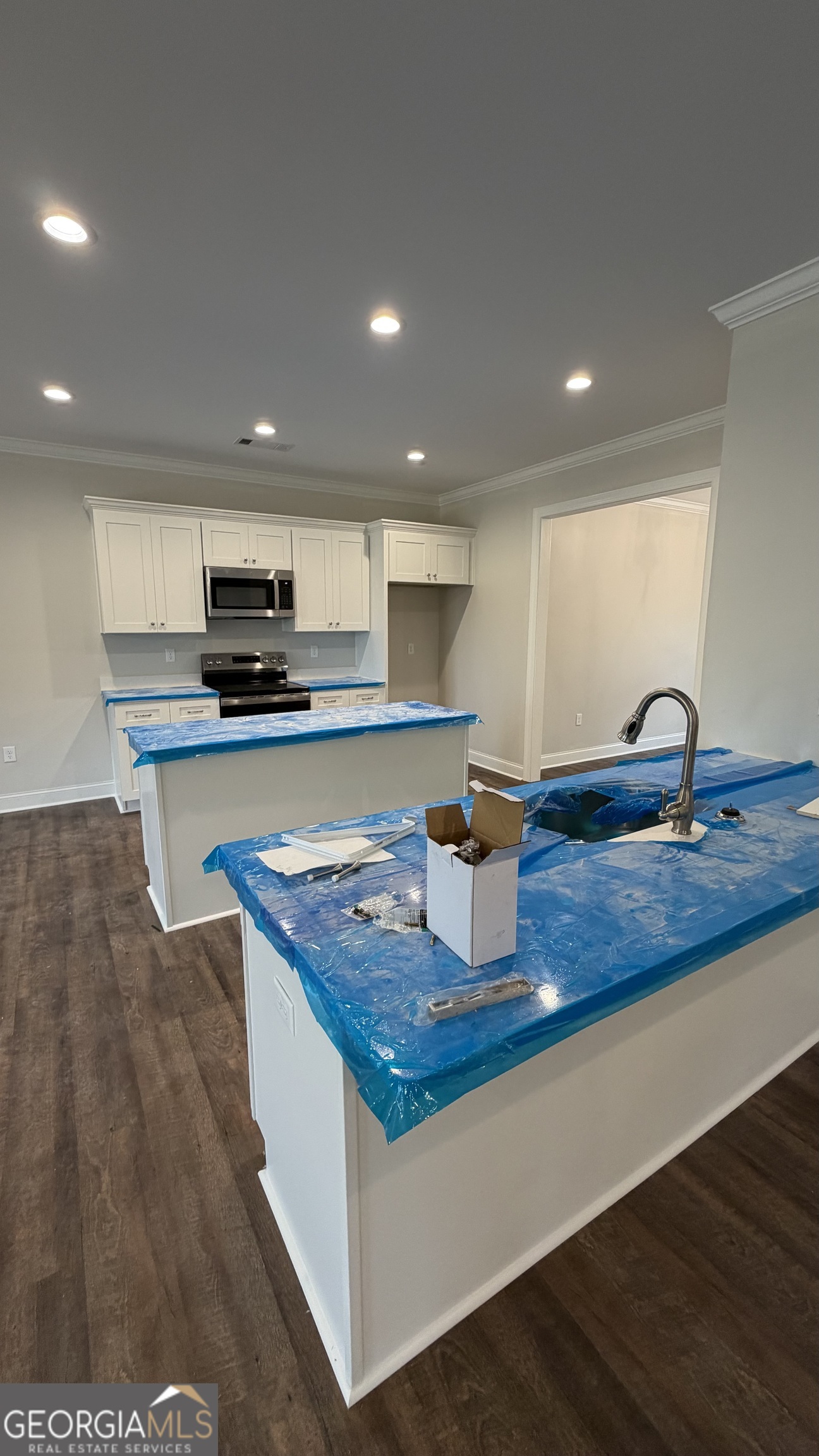 905 Sweet Magnolia Lane Dublin, GA 31021 - Photo 23 of 53 a kitchen with kitchen island granite countertop a sink a counter top space and appliances