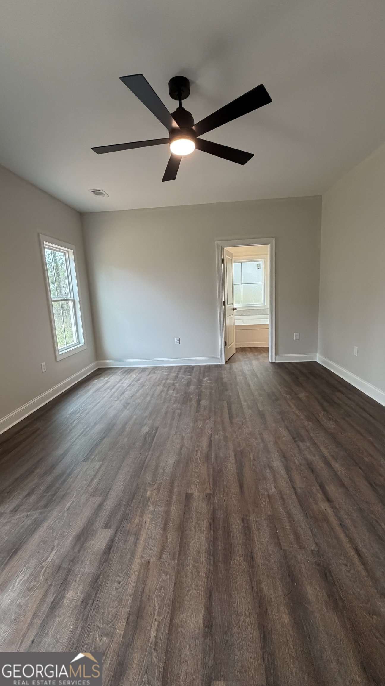 905 Sweet Magnolia Lane Dublin, GA 31021 - Photo 47 of 53 a view of empty room with wooden floor and fan