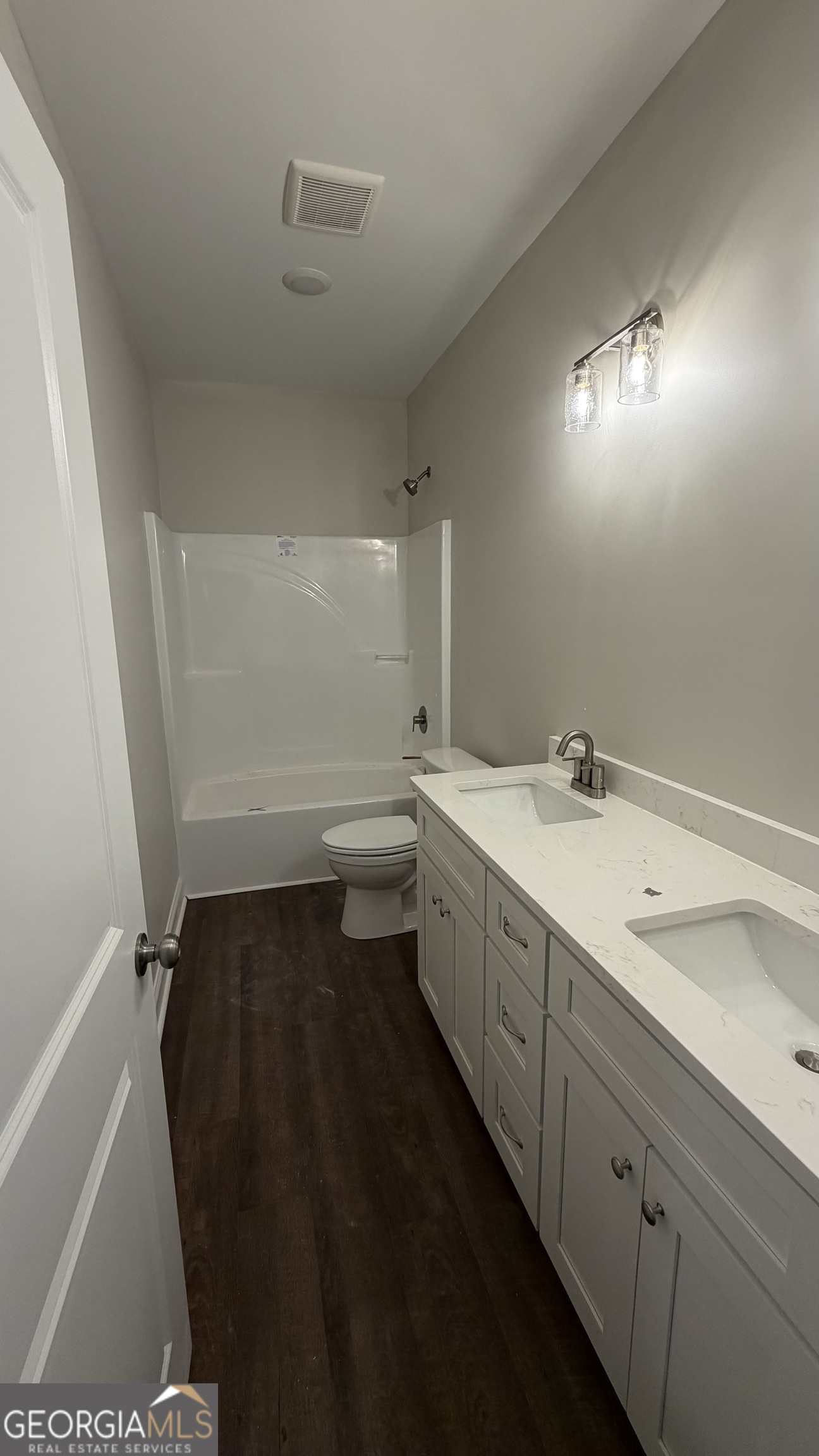 905 Sweet Magnolia Lane Dublin, GA 31021 - Photo 53 of 53 a bathroom with a double vanity sink and a toilet