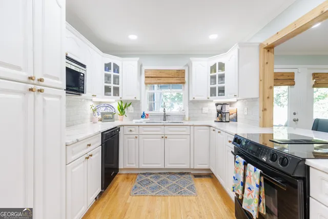 a kitchen with a sink stove and cabinets