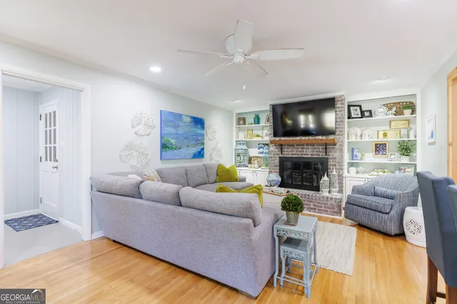 a living room with furniture a flat screen tv and a fireplace