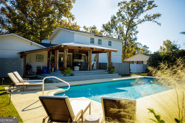 a view of a swimming pool with an outdoor space and seating area