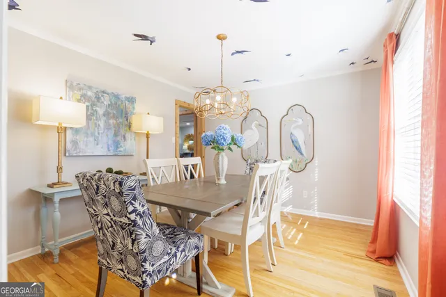 a view of a dining room with furniture and chandelier