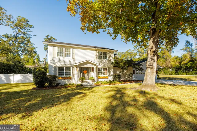 a view of a house with a large trees