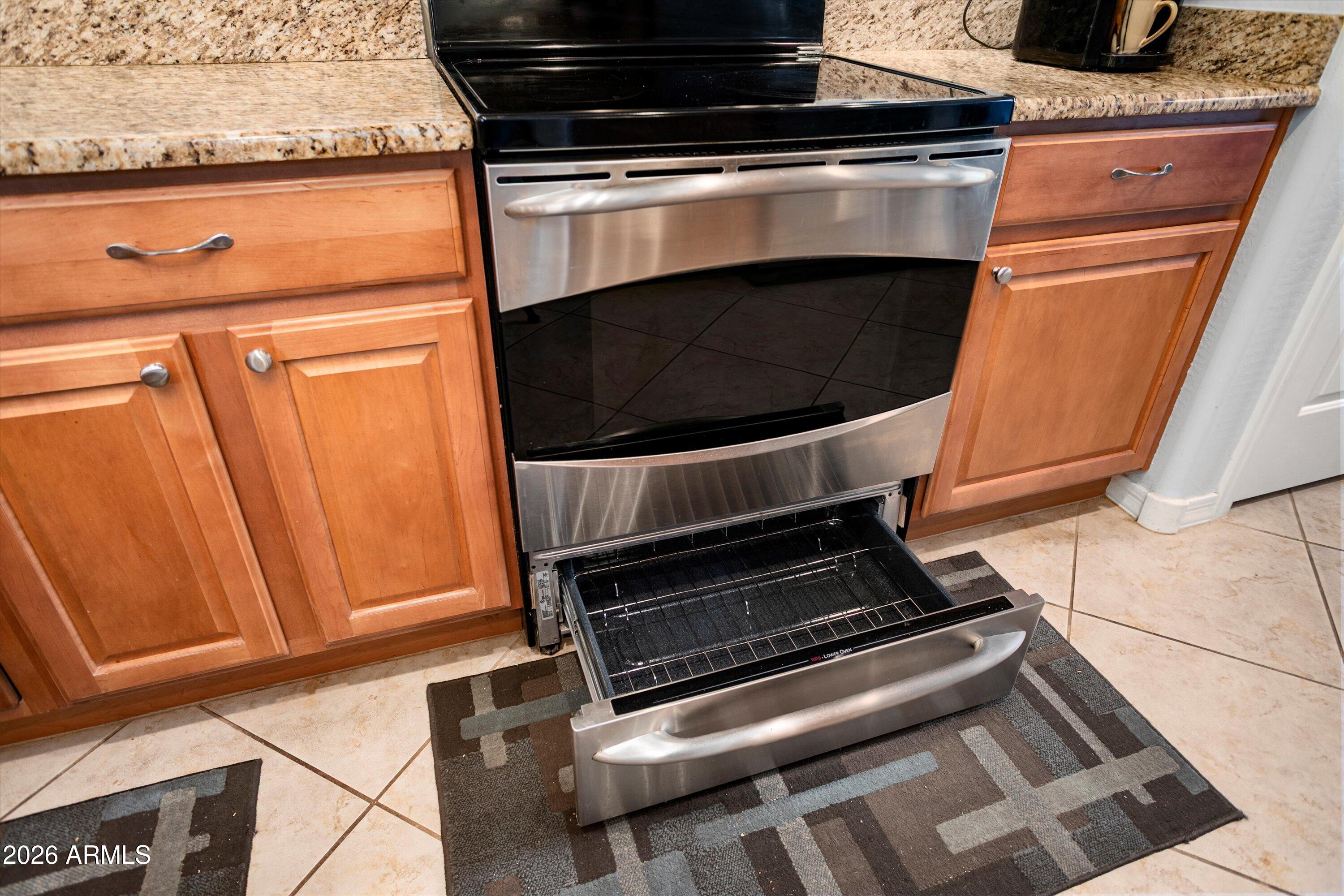 21613 North 261st Avenue Buckeye, AZ 85396 - Photo 11 of 52 a stove top oven sitting inside of a kitchen