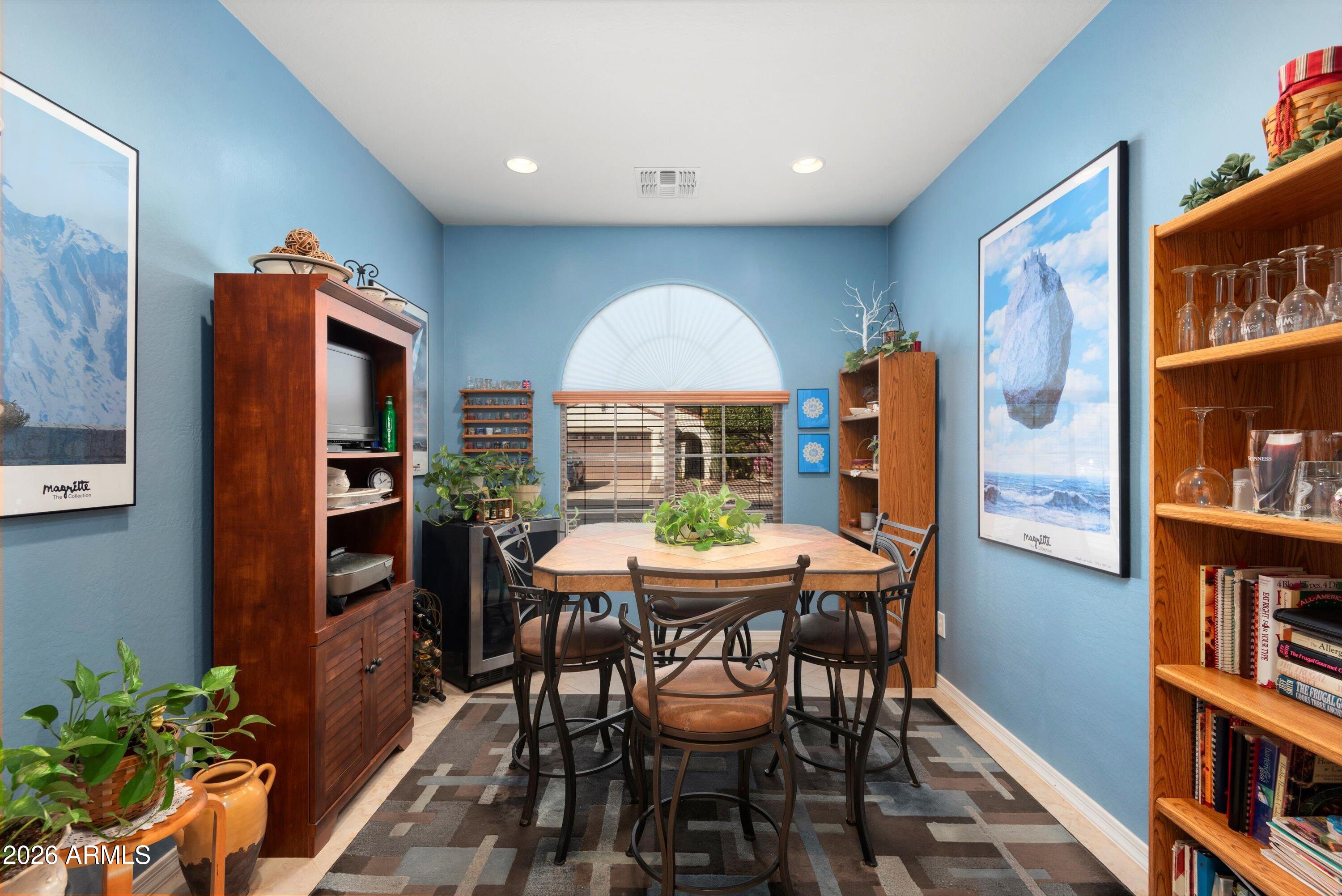 21613 North 261st Avenue Buckeye, AZ 85396 - Photo 12 of 52 a dining room with furniture and a floor to ceiling window